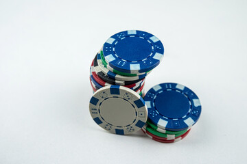 different color poker chips isolated on white gray background
