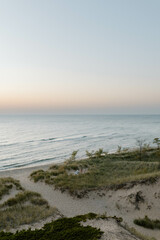 Beach sunset over sand dunes and beach grass