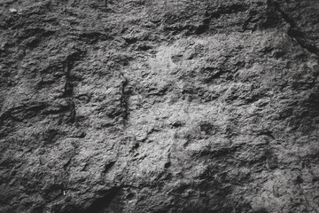 Rough grey stone wall for abstract background and texture for interior or exterior design. Beautiful patterns, space for work, banner, wallpaper close up.