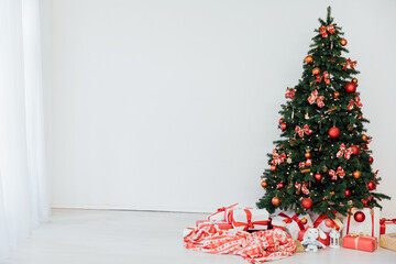 Interior with Christmas tree with gifts and toys as background New Year