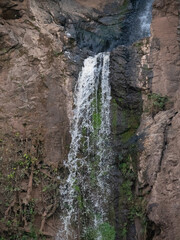 a waterfall cascades into a lake.  © Russell Kilburn