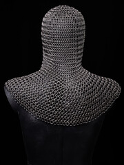 Medieval chain mail head protective cap on mannequin on head black backgound