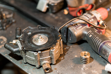 Mechanical Components on Workshop Table with Tools and Parts