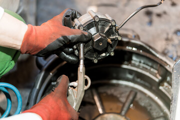 Mechanical Maintenance: A Technician Repairs an Engine Component with Precision