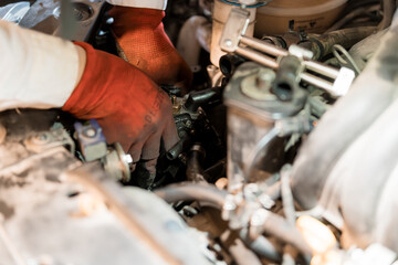 Automotive Mechanic Repairing Engine Components with Gloved Hands