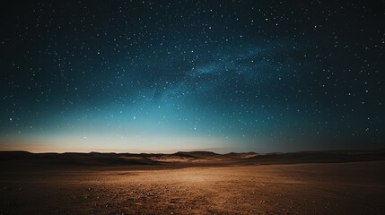 A breathtaking view of a starry night sky over a serene desert landscape.