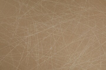 Old fiberboard with scratches as background, closeup