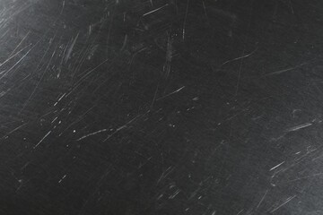 Old metal surface with scratches as background, closeup