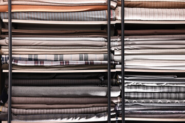 Many different types of fabric on shelves in professional atelier