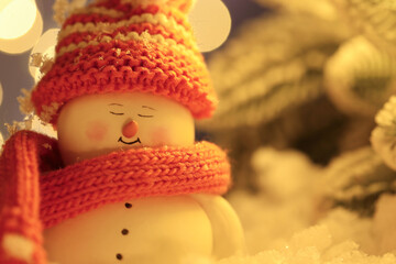 Cute decorative snowman against blurred background, closeup