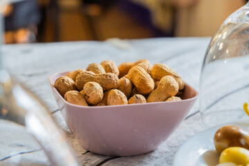 Peanut snack in a bowl, on a restaurant table.