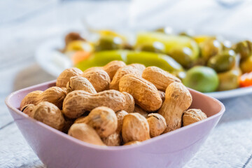 Peanut snack in a bowl, on a restaurant table.