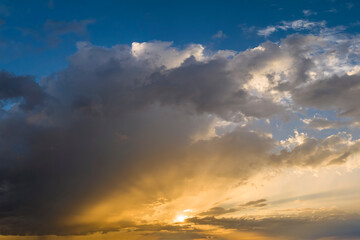 Amazing sunset skyscape. Evening sky with bright colorful orange and yellow clouds