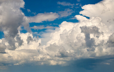 Bright landscape of blue sky with flying white clouds. Colorful summer skyscape