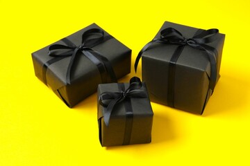 Beautiful gift boxes tied with bows on color background 
