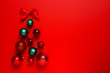 Festive balls in the form of a Christmas tree on a color background, top view