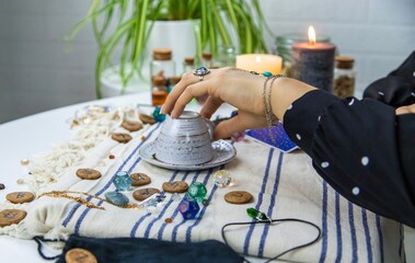 A fortune teller reads fortunes on coffee grounds. Selective focus.