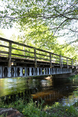 Old steel and wooden bridge over the river in Borki in Masuria, Poland