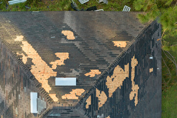 Natural disaster and its consequences. Hurricane Ian destroyed house roof in Florida residential area