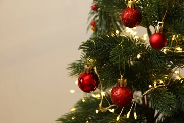 Christmas tree with decorations on a light background