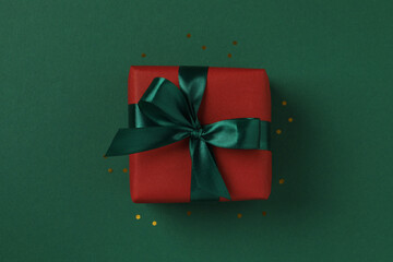 Beautiful gift box tied with bow on color background 