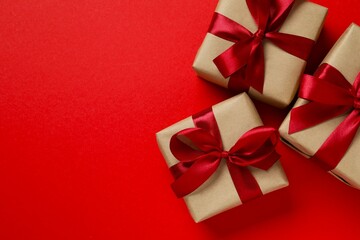 Beautiful gift boxes tied with bows on color background 