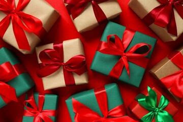 Beautiful gift boxes tied with bows on color background 