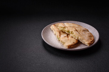 Round flatbread or pita with cheese, herbs, salt and spices