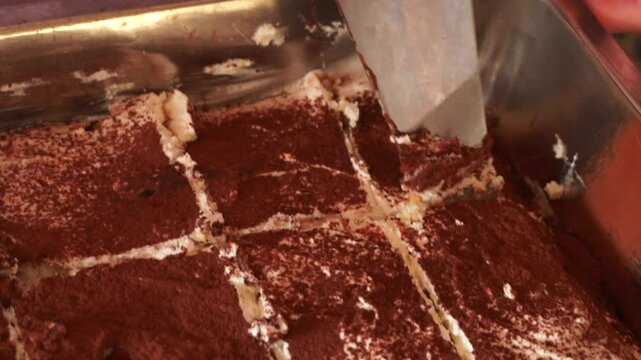Tiramisu. A classic Italian dessert. The tiramisu layer is soaked in coffee syrup, and on top of the dessert is a mascarpone cream cheese and sprinkled with cocoa powder.