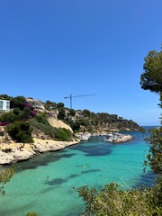 Fototapeta premium Stunning Coastal Landscape with Turquoise Waters and Rocky Cliffs in Mallorca, Spain