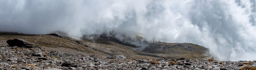 Cloudy over mountains on hiking trail to Mulhacen peak, Sierra Nevada National park, Andalusia, Spain