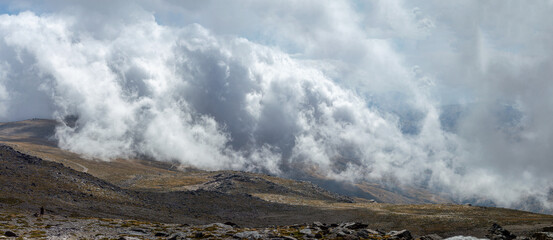 Cloudy over mountains on hiking trail to Mulhacen peak, Sierra Nevada National park, Andalusia, Spain