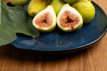 Fresh green figs on blue plate
