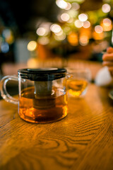 A cup and a teapot on a table in a restaurant. The concept of tea