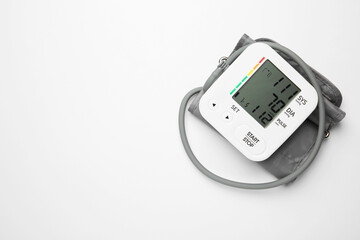 Blood pressure measuring device on light grey background, top view. Space for text