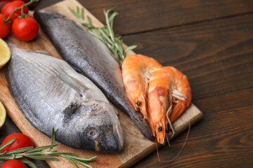 Fresh raw sea food and products on wooden table