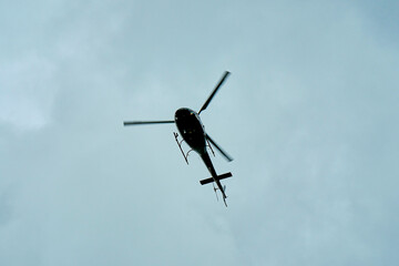 Commercial helicopter fly over the city