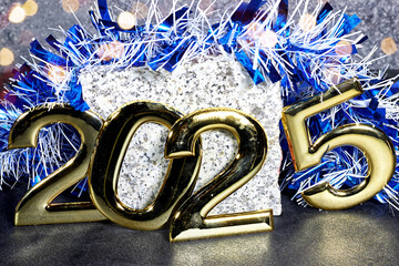 golden  numbers 2025 two thousand twenty five new year with blue tinsel and marble stone