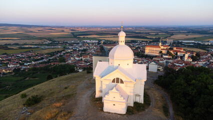 view of the holy hill at sunrise and the town of Mikulov in the distance