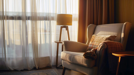Fototapeta premium Modern reading corner with armchair, lamp, and side table by window curtains, bathed in sunlight.