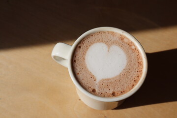 Hot chocolate drink with heart shaped foam