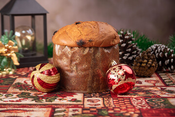 Christmas table with panettone, beautiful table decorated with Christmas objects and a delicious panettone, selective focus.