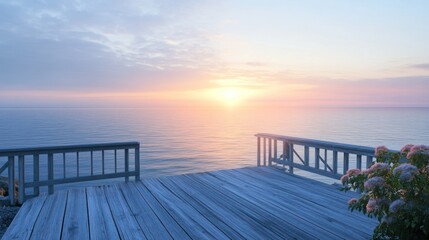 Wooden deck overlooking a calm sea at sunrise.