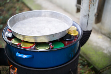 Glass cans with tomato sauce boiling. Preserving tomato sauce for winter. Canned food