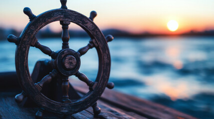Obraz premium Ship's wheel on a wooden deck with a serene sunset over the water. Concept of navigation and tranquility.