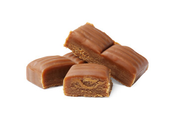 Tasty sweet caramel candies isolated on white