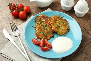 Delicious potato pancakes served on wooden table, closeup