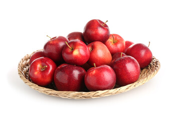 Fresh ripe red apples in wicker bowl isolated on white