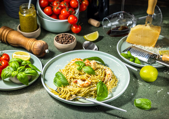 Delicious italian pasta with shrimps, pesto sauce, parmesan cheese, and basil leaves