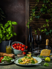 Delicious linguine with pesto, shrimps, parmesan and red wine on rustic table